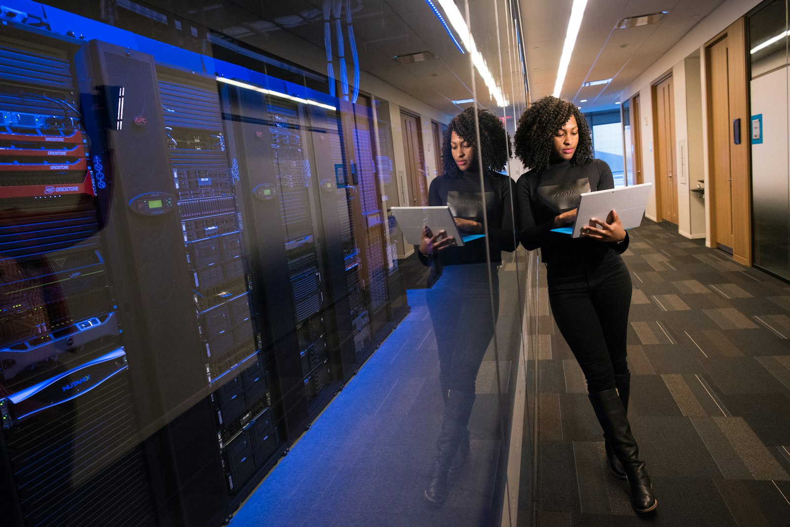 Consultant reviewing data on a laptop inside a data center
