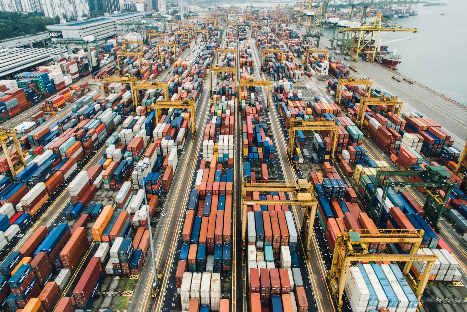 Aerial view of a container port with cranes and stacked containers